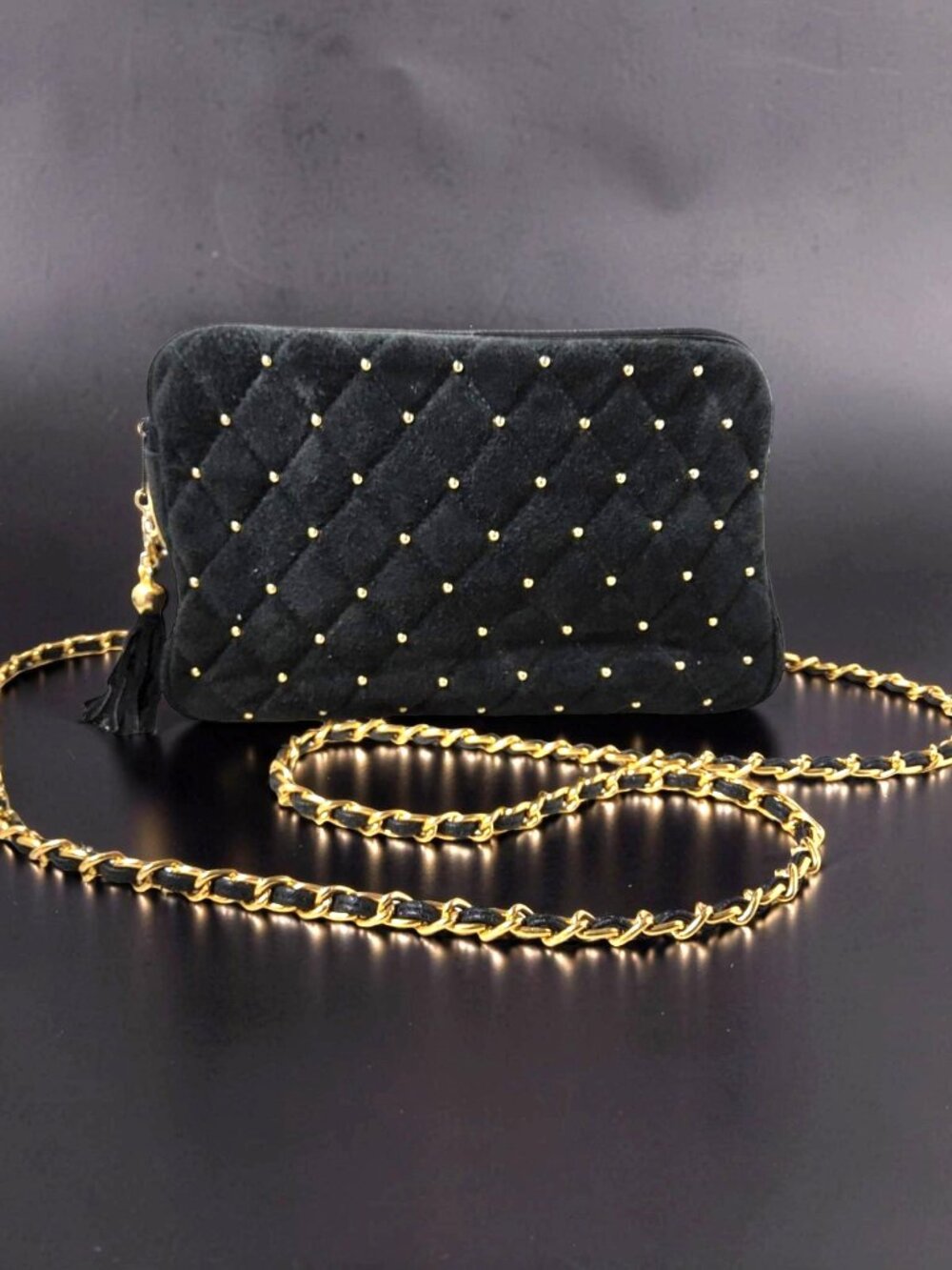 black quilted crossbody bag features delicate gold stud details and a matching c